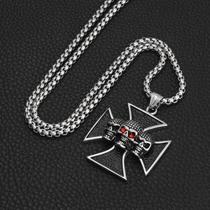 Punk style stainless steel necklace featuring a triple skull cross with red rhinestone eyes