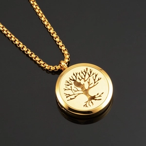 Detail of a golden Tree of Life pendant with intricate cutouts on a round polished disk