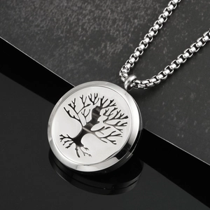 Macro shot of silver Tree of Life pendant with stainless steel box chain necklace