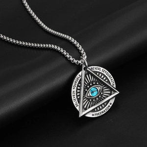 Macro view of Masonic All-Seeing Eye pendant with blue eye detail and engravings