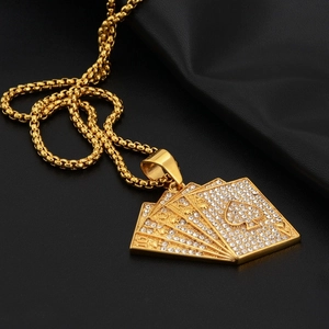 Close-up of gold iced-out royal flush poker pendant with crystal rhinestones on box chain