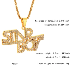 Macro shot of SIR BOY hip hop pendant necklace with shimmering crystals and gold chain