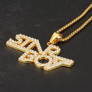 Detailed view of the gold hip hop necklace featuring an iced-out SENIOR letter pendant