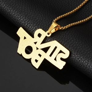 Macro shot of gold hip hop BOY letter pendant with matte texture on black leather