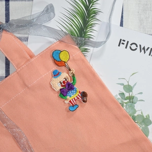 Cartoon clown embroidery patch with colorful balloons on a canvas tote bag