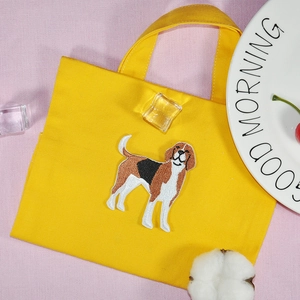 Yellow canvas tote bag with Beagle dog embroidery patch on a pink textured background