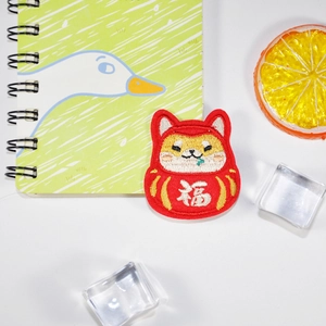 Cartoon Shiba Inu Daruma embroidery patch with white 'Fu' character on white background