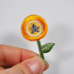 Detailed orange flower embroidery patch with green leaves for DIY clothing decor