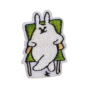 Cartoon rabbit embroidery patch featuring a grumpy bunny on a green chair for DIY clothing