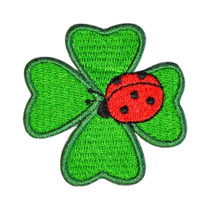 Exquisite four-leaf clover embroidered patch with a red ladybug on a white background