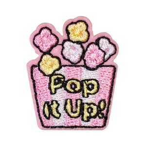 Embroidered popcorn patch with 'Pop it Up' text and vibrant pink and white stripes