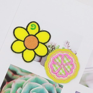 Sunflower and floral round embroidered patches displayed on a decorative botanical card