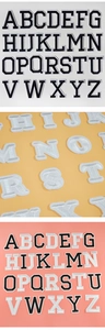 Close-up of 26 English letter embroidery patches showing fine fabric texture and neat edges
