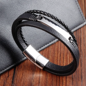 Détail du bracelet multicouche en cuir tressé noir avec fermoir magnétique en métal poli argent
