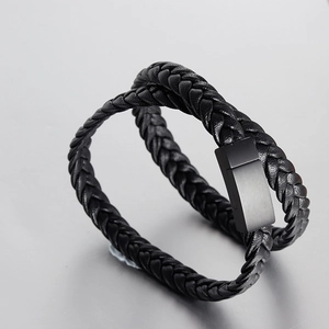 Macro view of double-layered black braided leather bracelet with matte magnetic clasp