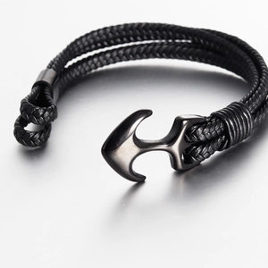 Men's braided black leather anchor bracelet with gunmetal nautical clasp on reflective base