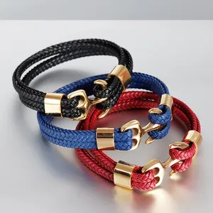 Close-up of anchor-shaped buckles on black, blue, and red braided leather bracelets