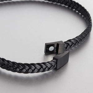 Close-up of black braided leather bracelet with matte black magnetic metal clasp detail