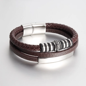 Detail of multi-layer brown leather bracelet with engraved silver beads and steel plate