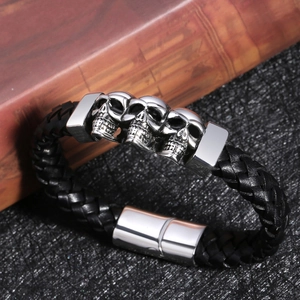 Punk men's braided black leather bracelet with silver skull metal charms and magnetic clasp