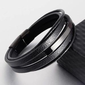 Detailed macro view of multi-layer black leather cord bracelet with magnetic clasp