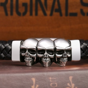 Punk men's black leather woven bracelet with three silver stainless steel skulls