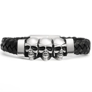 Mens black braided leather bracelet with three silver skulls and metal clasp