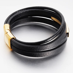 Detail of multi-layer black leather bracelet with gold stainless steel clasp