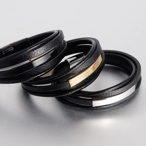 Detail of multi-layer black leather bracelets for men with polished metal magnetic clasps