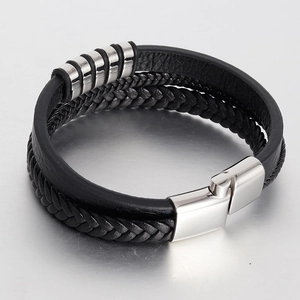 Detail of multi-layer braided leather bracelet with silver rings and magnetic clasp