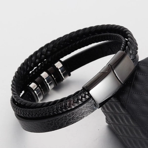 Detail of multi-layer braided leather bracelet with silver accents and magnetic metal clasp