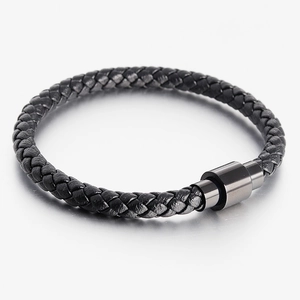 Detail of black braided leather bracelet for men with cylindrical magnetic metal clasp