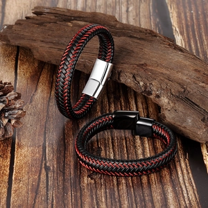 Men's braided leather bracelet with magnetic clasp on a rustic wooden background