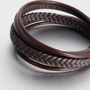 Close-up of brown multi-layer braided leather bracelet with vintage stainless steel detail