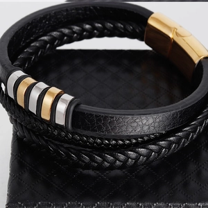 Detail of multi-layer braided leather bracelet with gold magnetic clasp and metal beads