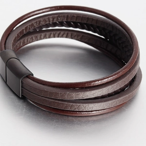Detailed close-up of dark brown multi-layer braided leather bracelet with matte black clasp