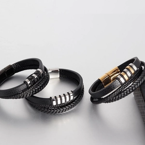 Close-up of multi-layer black braided leather bracelets with secure magnetic metal clasps
