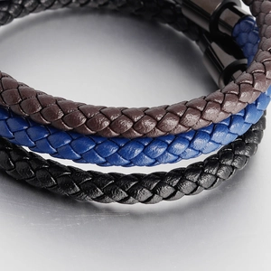 Close-up of three braided leather bracelets with industrial magnetic metal clasps
