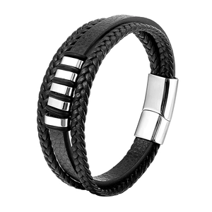 Detailed macro view of black multi-layer braided leather bracelet with silver magnetic clasp