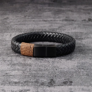 Men's braided black leather bracelet with magnetic metal clasp on stone background