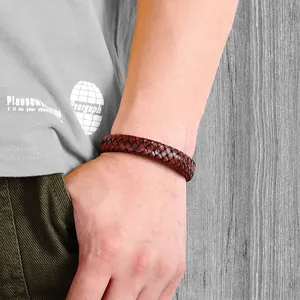 Close-up of men's braided brown leather bracelet with detailed woven texture on wrist