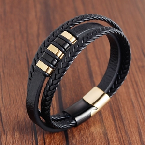 Macro detail of multi-layer braided leather bracelet with magnetic clasp and metal rings