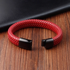 Braided red leather bracelet for men with black magnetic clasp on a wooden surface