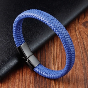 Blue braided leather bracelet with black matte metal clasp for men on dark wood