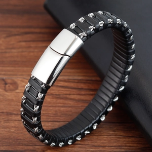 Men's braided leather bracelet with silver spiral metal accents and polished clasp