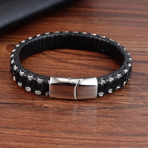 Detail of black braided leather bracelet with silver metal rope and magnetic clasp