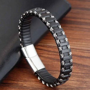 Detail of black braided leather bracelet featuring silver steel wire accents and metal clasp