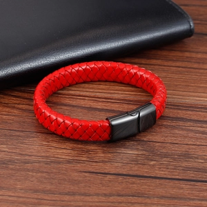 Detail of red braided leather bracelet for men featuring a gunmetal magnetic clasp on wood
