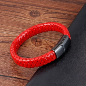 Detail of red braided leather bracelet featuring a sleek black magnetic metal clasp