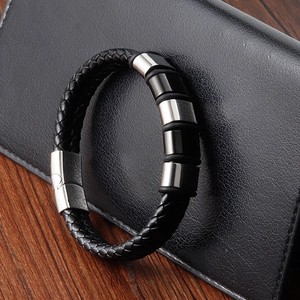 Detail of men's braided black leather bracelet with magnetic clasp and metal rings